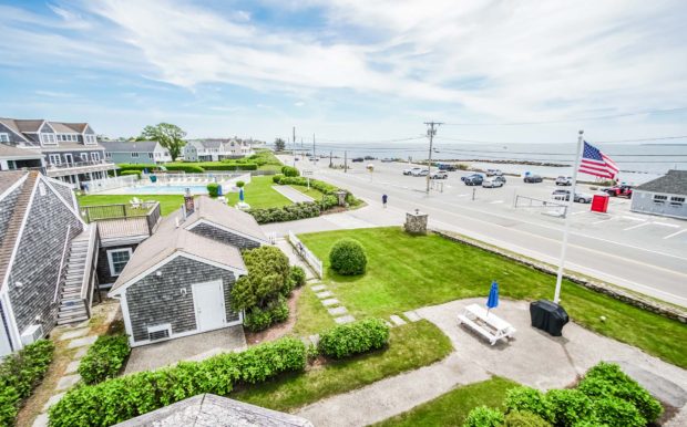 Aerial photo of resort grounds, street and partial ocean view.