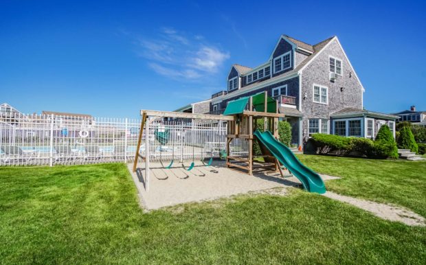 Photo of playground area overlooking pool and building exterior