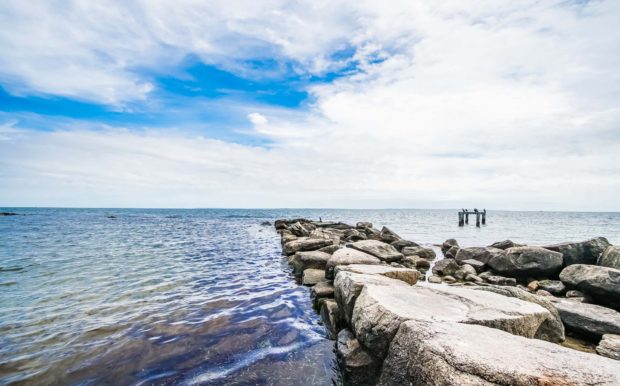 Photo of rock path in the ocean