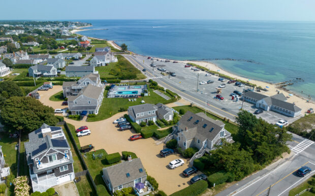 Aerial view of Beachside Village Resort highlighting the pool area, surrounding cottages, and nearby beach access.